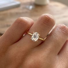 a woman's hand with a diamond ring on it