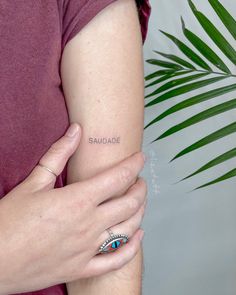 a woman holding her arm with an evil eye ring on it