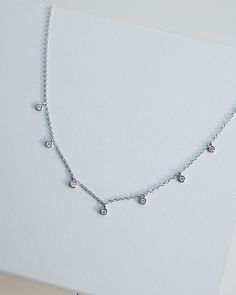 - Made in Sterling silver set with a high-quality Cubic Zirconia. - Stone size: 2.50 mm- Chain length : 15 inch Sterling silver925 Sterling Silver is an alloy made of 92.5% pure silver and 7.5% copper. We plate our silver jewelry in rhodium, which gives it extra shine and durability. Rhodium is one of the costliest precious metals due to its rarity.CareH2O sensitive. Avoid water when wearing your piece, because over time the sterling silver will oxidize.However, the oils in your skin help keep s Delicate Sterling Silver Necklace In White Gold, Dainty Silver Pendant Chain, Sterling Silver Jewelry With Delicate Chain Dangle, Classic Cubic Zirconia Dangle Necklaces, Sterling Silver Fine Jewelry With Delicate Chain, Fine Jewelry With Cubic Zirconia And Silver Chain, Sterling Silver Necklaces With Delicate White Gold Chain, Classic Dangle Cubic Zirconia Necklaces, Silver Sterling Silver Necklaces With Diamond Accents