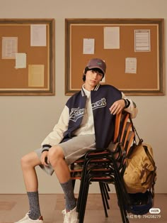 a man sitting on top of a wooden chair