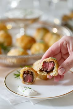 a person is holding a piece of food on a plate