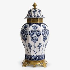 a blue and white vase with gold trimmings on the top is shown in front of a white background