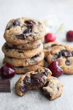 chocolate chip cookies and cherries are stacked on top of each other