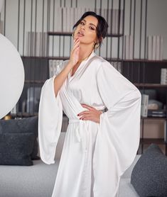 Bridal robe with wide sleeves Do you want to look irresistible in your pre-wedding photos? Or surprise everyone with your great look? You are now looking at a wonderful robe that is designed to make you truly irresistible! This is exactly that highlight that is needed for the bride's morning to be completely successful. Or not the bride's morning, but every morning of any day!        This robe of incredible beauty will raise your status both in your own eyes and in the eyes of everyone around yo White V-neck Robe For Sleep, Elegant V-neck Kimono For Wedding, Elegant V-neck Wedding Kimono, Elegant Wedding Night Sleepwear With Kimono Sleeves, Satin Robe With Kimono Sleeves For Wedding Night, Elegant Sleepwear With Kimono Sleeves For Wedding Night, White Wedding Gown With Kimono Sleeves, White Satin Finish Dress For Wedding Night, Elegant White Party Nightgown