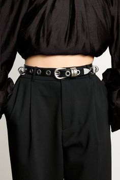 Based on the best-selling Hollyhock, the Revenge belt emerges to be a luxurious core belt in the Déhanche repertoire. Its grommets and rings pay homage to the rebellious spirit of punk fashion and S&M subculture, resulting in an accessory that captivates with its audacious charm. Handcrafted in Italy, the belt features smooth black leather, grommets and ring charms that are placed individually by hand. Black Chain Belt For Festival, Punk Black Chain Belt With Belt Loops, Black Punk Chain Belt With Belt Loops, Black Chain Belt With Belt Loops For Festivals, Edgy Black Chain Belt For Festival, Edgy Black Belt Buckle With Removable Belt, Trendy Black Chain Belt With Removable Feature, Black Belt With Removable Feature For Festivals, Edgy Chain Belt For Night Out