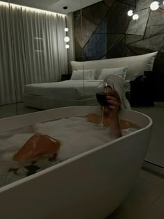 a woman taking a selfie in a bathtub with her feet in the water