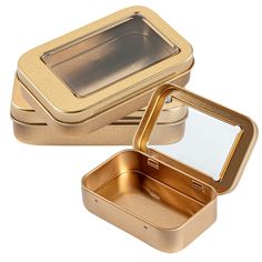 two gold tins with mirrors on them sitting next to each other in front of a white background