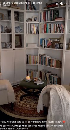 a living room filled with lots of white furniture and bookshelves full of books