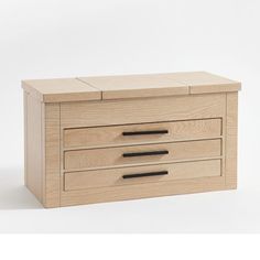 a wooden chest with three drawers on one side and two black handles on the other