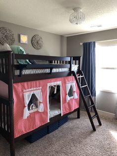 a child's bedroom with a bunk bed and curtains on the windowsills