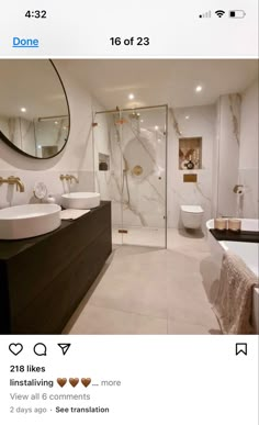 an instagramted photo of a white bathroom with gold accents and marble counter tops