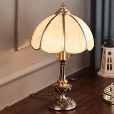 a table lamp sitting on top of a wooden floor