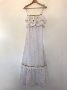 White Cotton Dress | Maxi Summer Dress | Long Prairie Boho Dress | Vintage Dress | Lace Festival Peasant Bohemian | Ruffled Sleeveless Gown | see through dress | white beach dress |  broderie eyelet lace pattern | Tags Description: A brilliant prairie dress from the late 1970s (perhaps early 1980s).  This vintage piece is white and made of cotton.  It is also not see through and has a white inner lining. It features a brilliant broderie eyelet lace pattern throughout and has ruffle detail on the Sleeveless Bohemian Maxi Dress With Ruffles, Bohemian Maxi Dress With Ruffled Straps, Bohemian Maxi Dress With Ruffle Hem And Straps, Bohemian Sundress With Ruffled Straps For The Beach, Bohemian Sleeveless Sundress With Ruffle Hem, Bohemian Sundress With Ruffled Straps, Bohemian Sundress With Ruffle Hem And Straps, Bohemian Sundress With Ruffle Hem And Ruffled Straps, Bohemian White Tiered Sundress