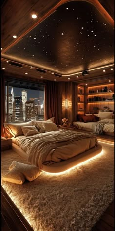 a large bed sitting in the middle of a bedroom next to a window with city lights on it