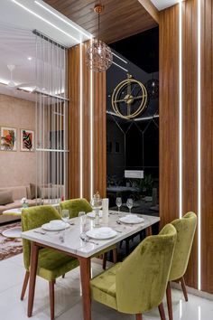 a dining room with green chairs and a white table