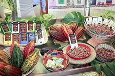 several baskets filled with different types of food on top of a wooden table next to plants