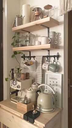 a kitchen shelf filled with pots and pans