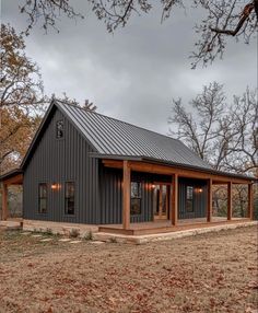 a black metal building with two covered porchs on the front and side of it