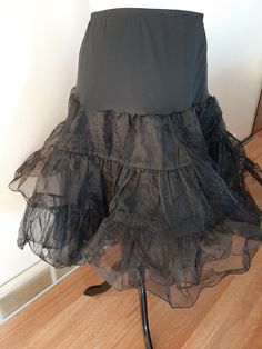 "Vintage Womens Black Nylon Full Circle Petticoat Slip/ Pin Up Rockabilly Half Slip Size M-L Very Good Vintage Condition. No Rips, Tears Or Stains. Elastic Has Probably Lost Some Of It's Stretch. If Replaced Could Fit A Size Small Also. .5\" Elastic Nylon Stretchy Top Section 2 17\" Tiered Stiff Nylon Ruffled Sections Nylon Undercoat Waist 30\"-43\" Hips 50\" Length 26\"" Party Can-can Petticoat With Tiered Skirt, Can-can Petticoat For Costume Party, Stretch Petticoat For Costume Party, Party Skirt With Can-can Crinoline, Retro Fitted Petticoat For Costume Party, Gothic Black Petticoat With Attached Cancan, Vintage Black Skirt For Costume Party, Black Ruffled Full Skirt Petticoat, Black Fitted Gothic Petticoat