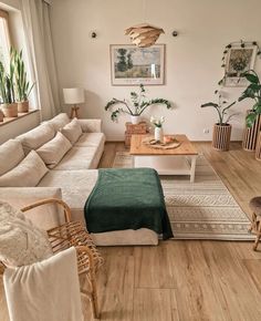 a living room filled with furniture and plants