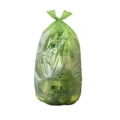 a bag filled with green vegetables sitting on top of a white surface