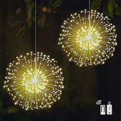 two lights that are hanging from strings in the air with string lights attached to them