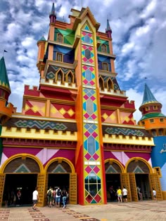 people are standing in front of a colorful building