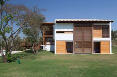 a small white house with wooden shutters on the side