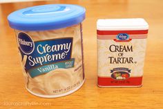 two yogurt containers sitting on top of a wooden table