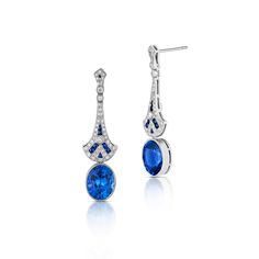 These lovely Art Deco style drop earrings are crafted in 18 karat white gold and feature two oval cut heated blue sapphires with a total weight of 8.09 carats. Adorning the two sapphires are 1.00 total carats of round brilliant cut diamonds and 0.44 total carats of calibre cut blue sapphires set with milgrain detailing. Reference Code: 34975 Shop other beautiful pieces in our Earring Collection.For inquiries on the piece please contact: boutique@shsilver.com Luxury Platinum Blue Earrings, Luxury Blue Platinum Earrings, Classic Blue Platinum Earrings, Elegant Blue Platinum Earrings, Elegant Sapphire Earrings With Polished Finish, Paris Ring, Sapphire And Diamond Earrings, Jewelry Appraisal, Bridal Engagement Rings