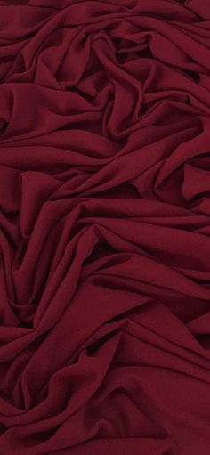 an image of a bed with red sheets