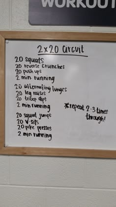 a white board with writing on it in front of a wall mounted workout sign that reads 20x20 circuit