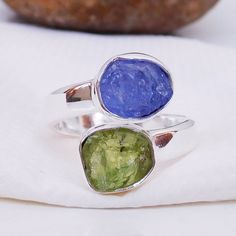 Natural Raw Tanzanite & Peridot Ring, Multi Stone Ring, Adjustable Ring, Handmade Silver gemstone Ring. Product:- Ring Modal no:- U379 Metal:- 925 Sterling Silver Gemstone :- Peridot & Tanzanite Gemstone size:- 8x10 mm approx. Finishing:- Shiny Silver We are using Pure 925 (Stamped) Sterling Silver with Natural Gemstone Jewelry, all of our jewelry designs are Handmade. We are adding new creative designs in our store regularly, for new handmade stuff please get touch with our store. We al Green Stackable Sapphire Ring Gift, Green Sapphire Stackable Ring For Gift, Stackable Green Sapphire Ring Gift, Green Stackable Sapphire Ring Perfect For Gifts, Gift Green Stackable Sapphire Ring, Adjustable Green Nickel-free Ring, Adjustable Round Peridot Ring, Adjustable Green Round Birthstone Ring, Adjustable Peridot Ring