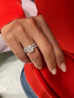 a woman's hand wearing a diamond ring