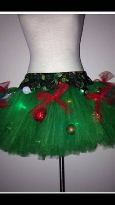 a green skirt with red bows and lights on it