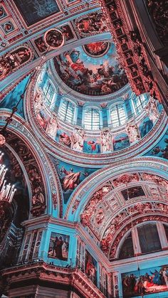 looking up at the ceiling in a building with many paintings on it's walls