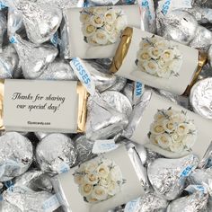 white roses are wrapped in silver foil and placed on top of each other with a sign that says thanks for shopping our special day