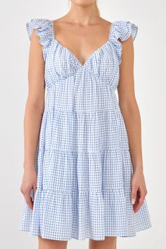 Get ready to look pretty in pink with this Gingham Printed Tiered Mini Dress. With ruched sweetheart neckline, ruffled shoulders and a tiered bodice, this dress is sure to make you stand out in a crowd. The flounce and lined skirt make this dress even more feminine and sweet. And with a side invisible zipper closure, t Pink Gingham Dress, Milkmaid Dress, Knit Loungewear, Strapless Bodycon Dress, Tiered Mini Dress, Roller Rabbit, English Factory, Knit Outerwear, Stand Out In A Crowd