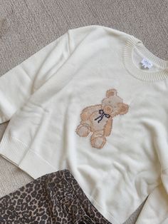 Oversized fit, crewneck style sweater with bear and bow detail. Teddy Bear Holding Heart, Bear Holding Heart, Teddy Sweater, Holding Heart, Crewneck Style, Heart Sweater, Style Sweater, Bow Detail, Oversized Fits