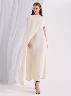 WF ATELIER Off White Two-piece Dress and Cape, you can style separately with different outfıt Model height: 177 CM 100% Viscose Length: 137 cm Cape Long sıde :145 cm Pre-draped Cape Evening Dress, Elegant Spring Evening Dress With Cape Sleeves, Cream Pre-draped Evening Dress, Elegant Fitted Cape Dress, Formal Cream A-line Maxi Dress, Formal Fitted Cape Dress, Cream A-line Maxi Dress For Evening, A-line Beige Maxi Evening Dress, Chic Cape Evening Dress