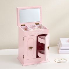 a pink jewelry box with its door open