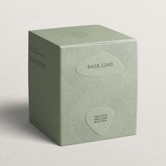 A cardboard soft green tea box with an embossed line pattern inspired by Kyoto gardens. It features the company, Baseline, logo and product description inside a pebble shape. Matcha Packaging, Mises En Page Design Graphique, Visuell Identitet, Luxury Packaging Design, Skincare Branding, Cosmetic Packaging Design, Skincare Packaging, Perfume Packaging, Candle Packaging