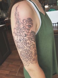 a woman with a flower tattoo on her arm