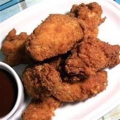 fried chicken and dipping sauce on a white plate