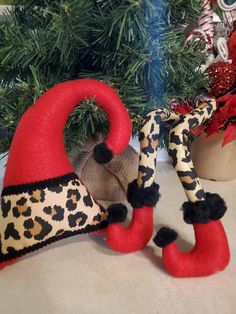 two red and black stuffed animals next to a christmas tree