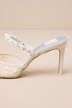 The Dolce Vita Katik Ivory Mesh Pearl Pointed-Toe Mule Pumps will be the perfect finishing touch to all your most elegant bridal looks! These glamorous pumps feature a sheer mesh pointed-toe upper embellished with stunning faux pearl details (of varying sizes) and a slender vamp strap adorned with more luminous faux pearl beads (and elastic at the side for fit). A stunning stiletto heel lends an extra-sultry finish to this luxe design. 3. 25" stiletto heel. Lightly cushioned insole. Felted rubbe Elegant Pearl-embellished Wedding Shoes For Evening, Elegant Pearl Embellished Heels For Wedding Guest, Chic Cream Wedding Shoes For Events, Chic Cream Wedding Shoes For Event, Elegant Pearl White Closed Toe Heels, Feminine Cream Wedding Shoes For Evening, Cream Ankle Strap Wedding Shoes, Elegant High Heel Bridal Accessories, Pearl White Bridal Accessories For Party