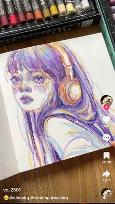 someone is drawing with colored pencils on paper