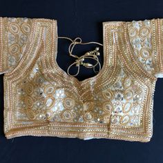 Embellished Readymade Saree Blouse Blouse Size - 36" To 44" Inches . Quantity - One Blouse/ One Choli Wash : Dry Clean And Hand Wash Fabric : Banglori Silk Traditional Embellished Embroidered Top For Festive Occasions, Traditional Festive Embellished Embroidered Top, Festive Traditional Embellished Embroidered Top, Elegant Festive Tops For Navratri, Elegant Embellished Blouse Piece For Navratri, Elegant Tops For Navratri Celebration, Embellished Tops For Diwali Festive Occasion, Gold Short Sleeve Tops For Festivals, Embellished Tops For Festive Diwali Season