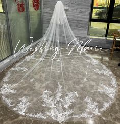 a wedding veil is on display in front of a window