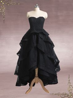 a mannequin with a black dress on display